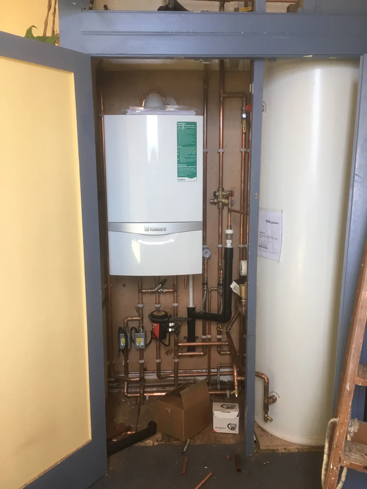 Boiler and hot water cylinder installation with copper pipework